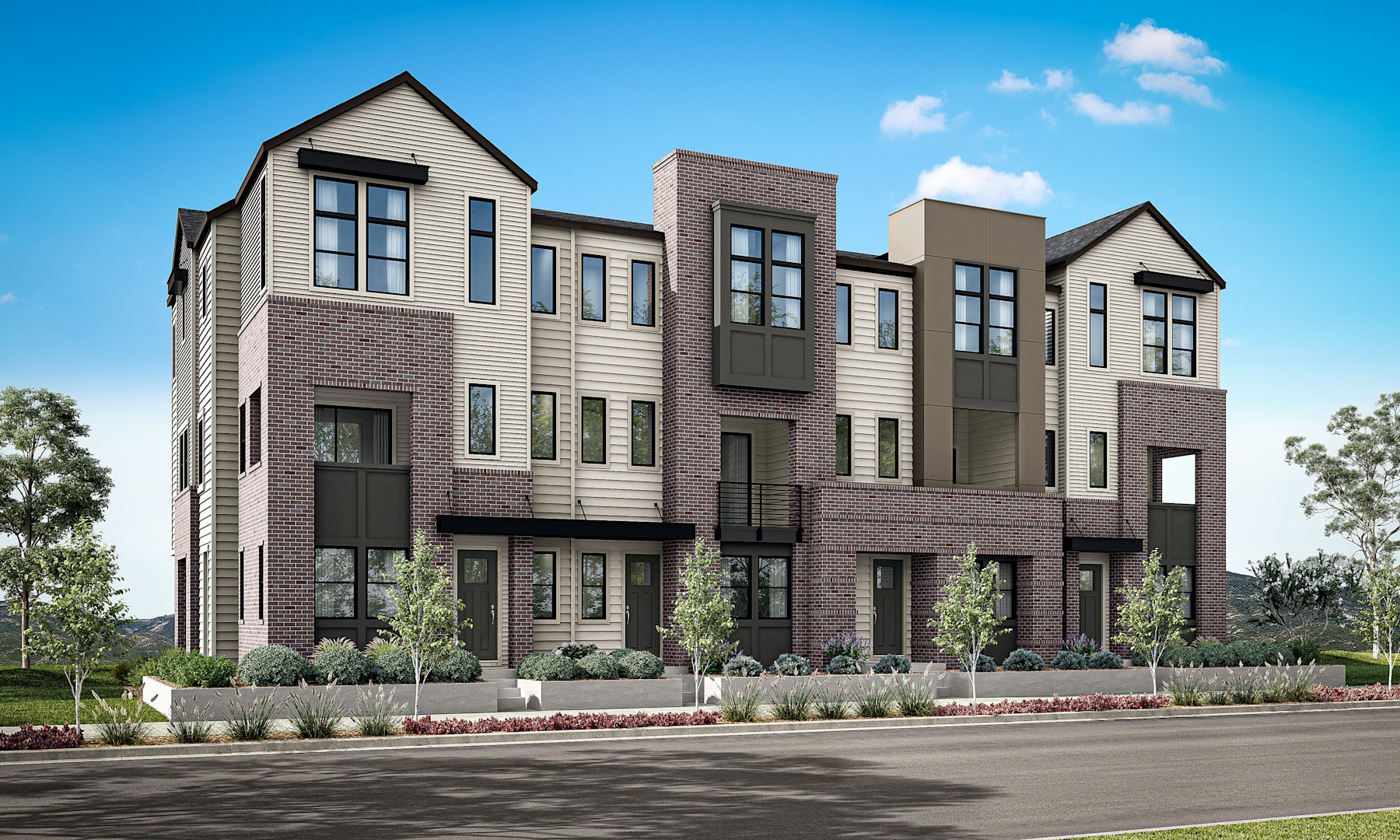 A modern multi-story residential building with a mix of siding materials, including wood and brick, surrounded by landscaping and a paved road in the foreground.