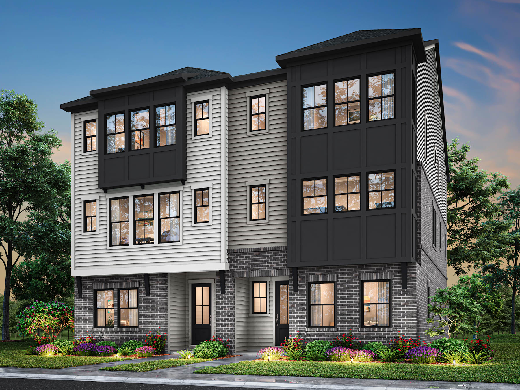 A multi-story residential building with a modern, sleek design featuring a combination of gray siding and black accents, surrounded by lush greenery and landscaping.