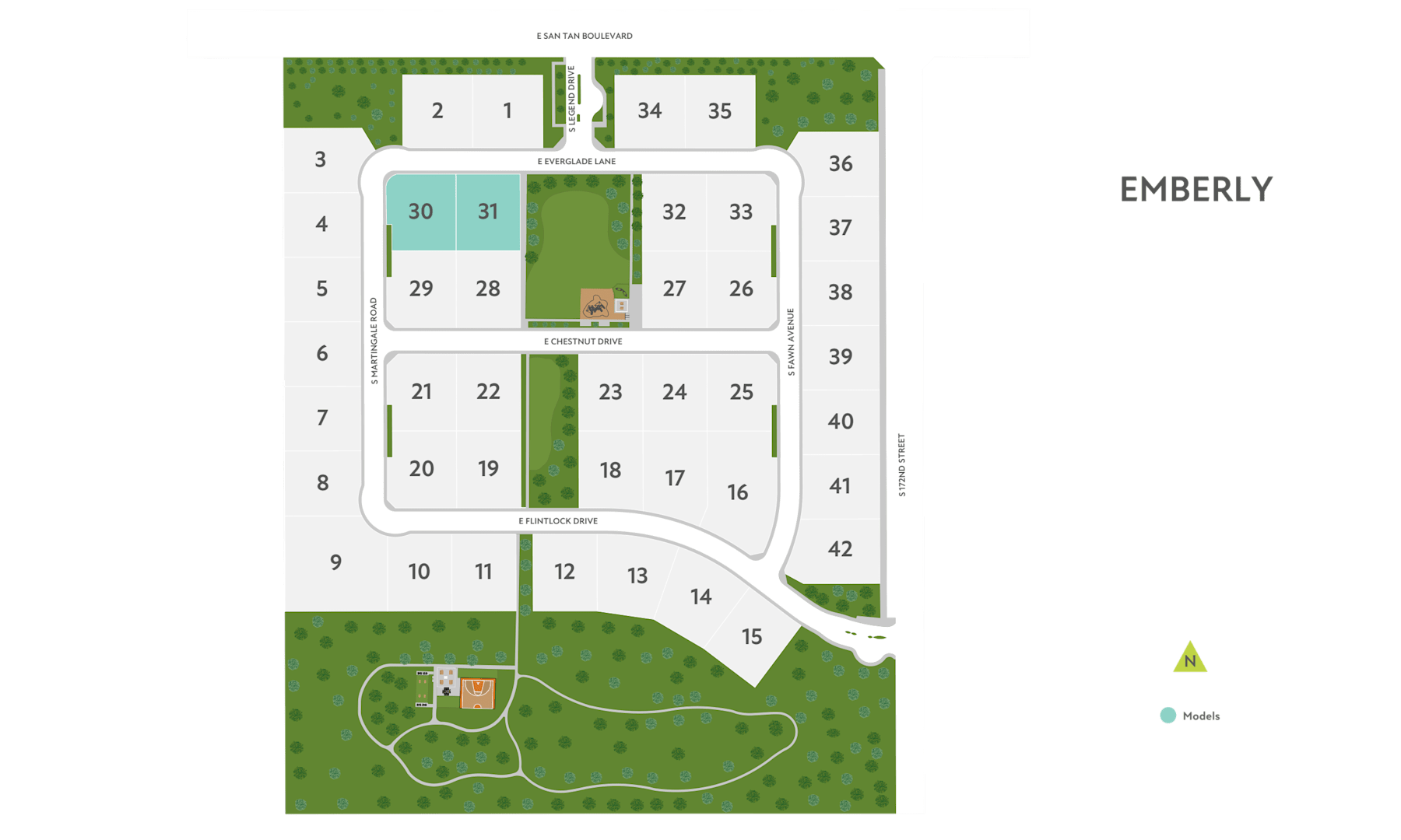 A residential community layout with numbered lots, green spaces, and a road network.