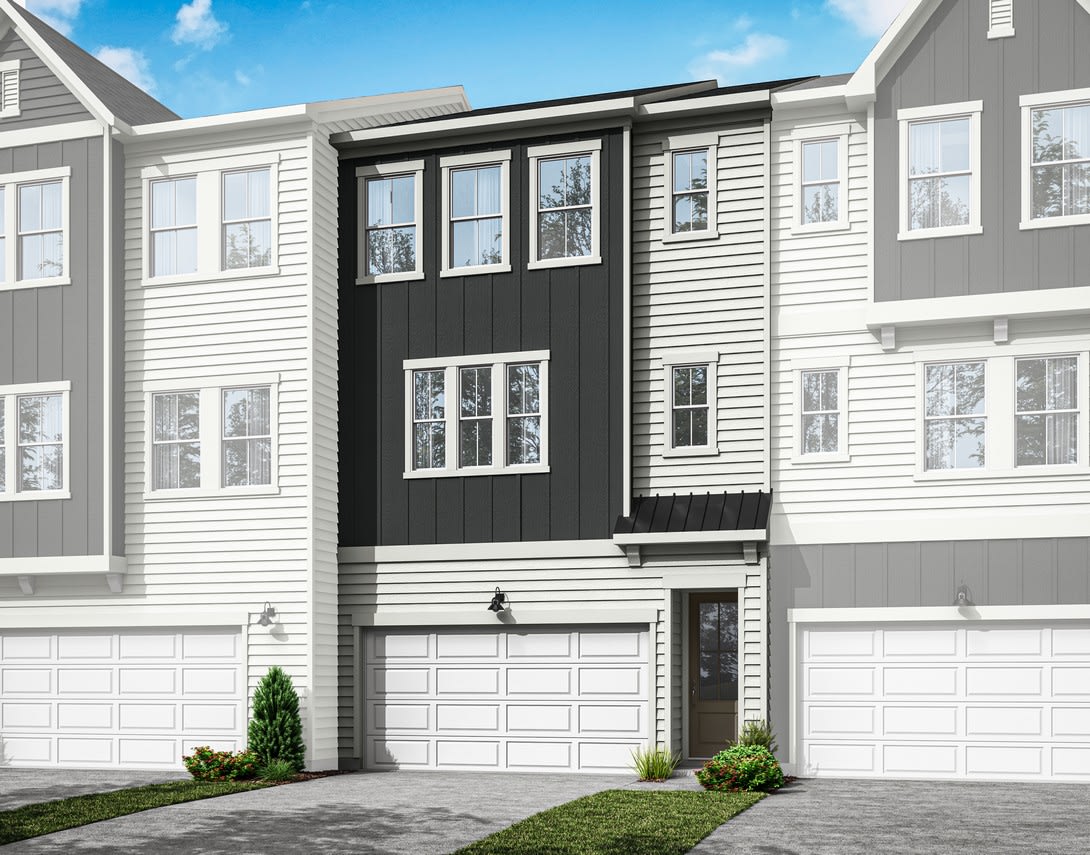 A modern townhouse with a gray exterior, white trim, and a black front door, set against a blue sky with some clouds.