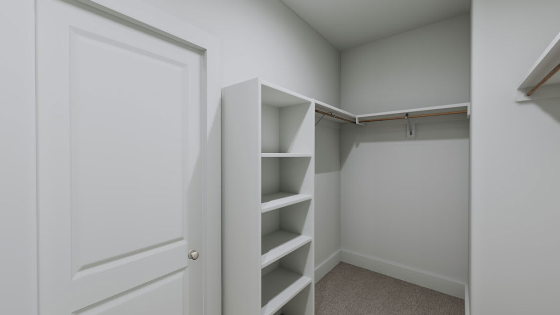 A white, minimalist closet with shelves and a hanging rod, situated in a room with light-colored walls and carpeted flooring.