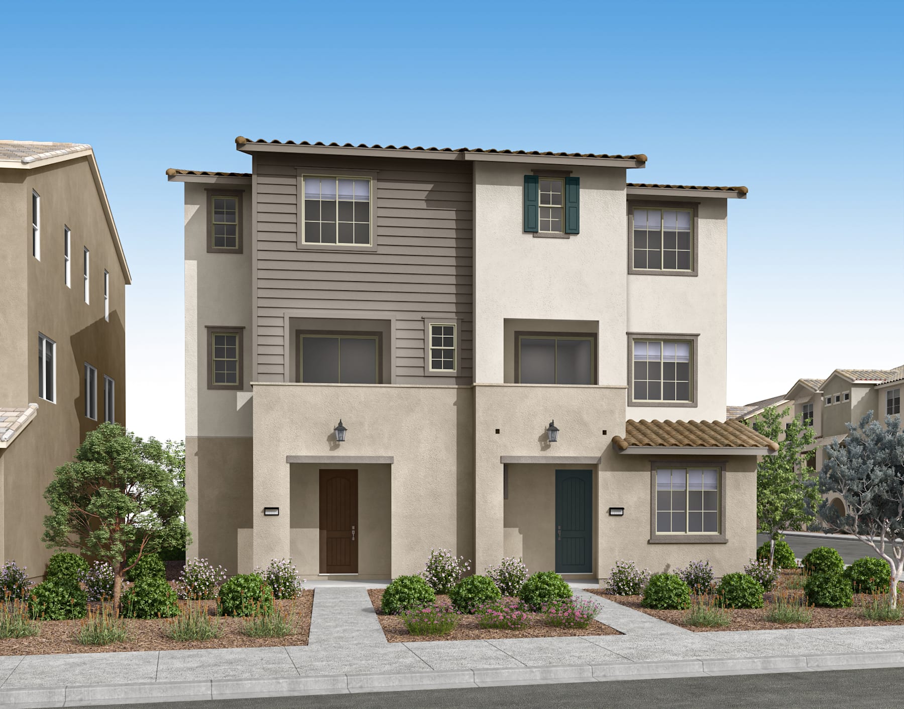 A two-story residential building with a Mediterranean-style architecture, surrounded by landscaped gardens and a paved walkway in the foreground.