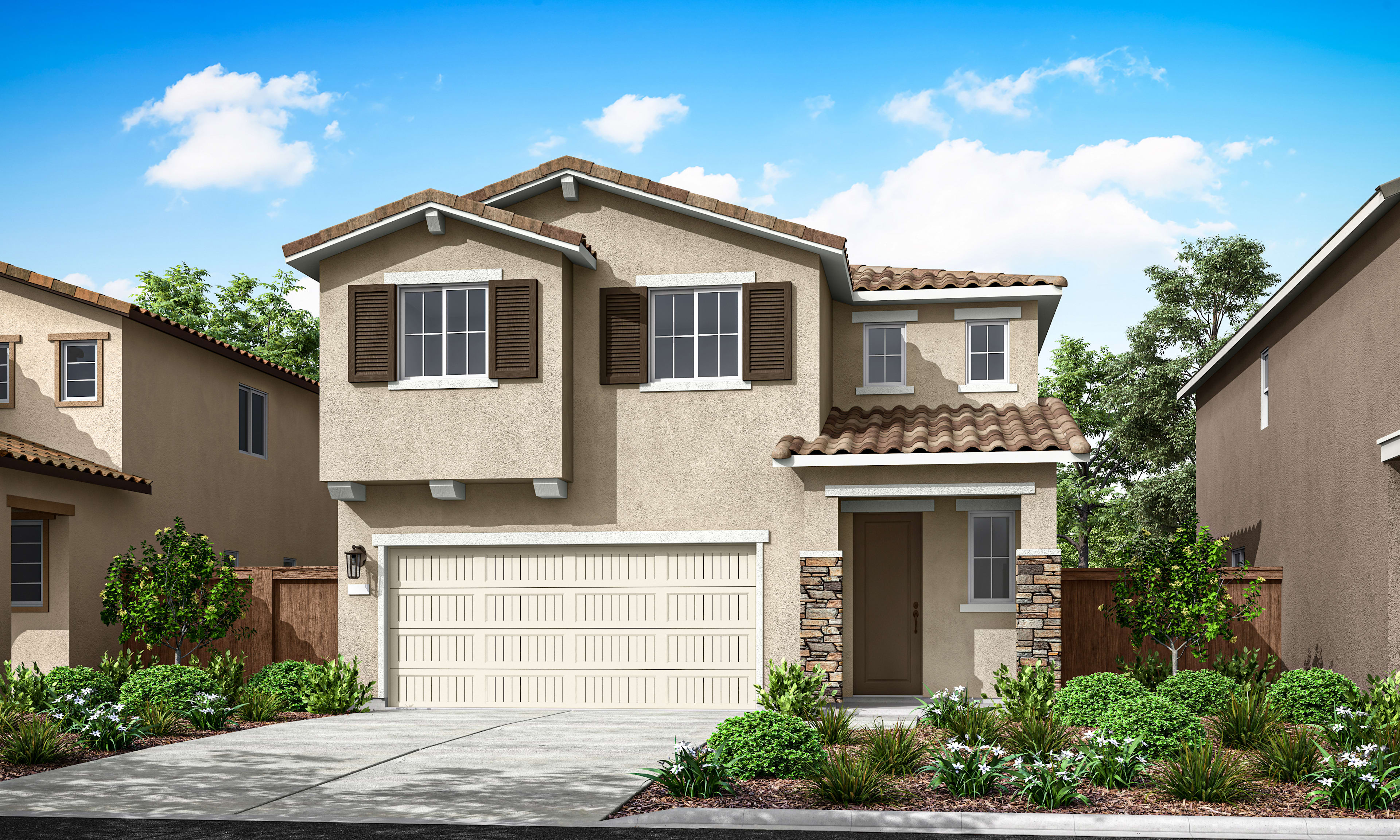 A two-story stucco house with a tiled roof, a garage door, and a well-landscaped front yard surrounded by trees and shrubs against a clear blue sky with fluffy white clouds.