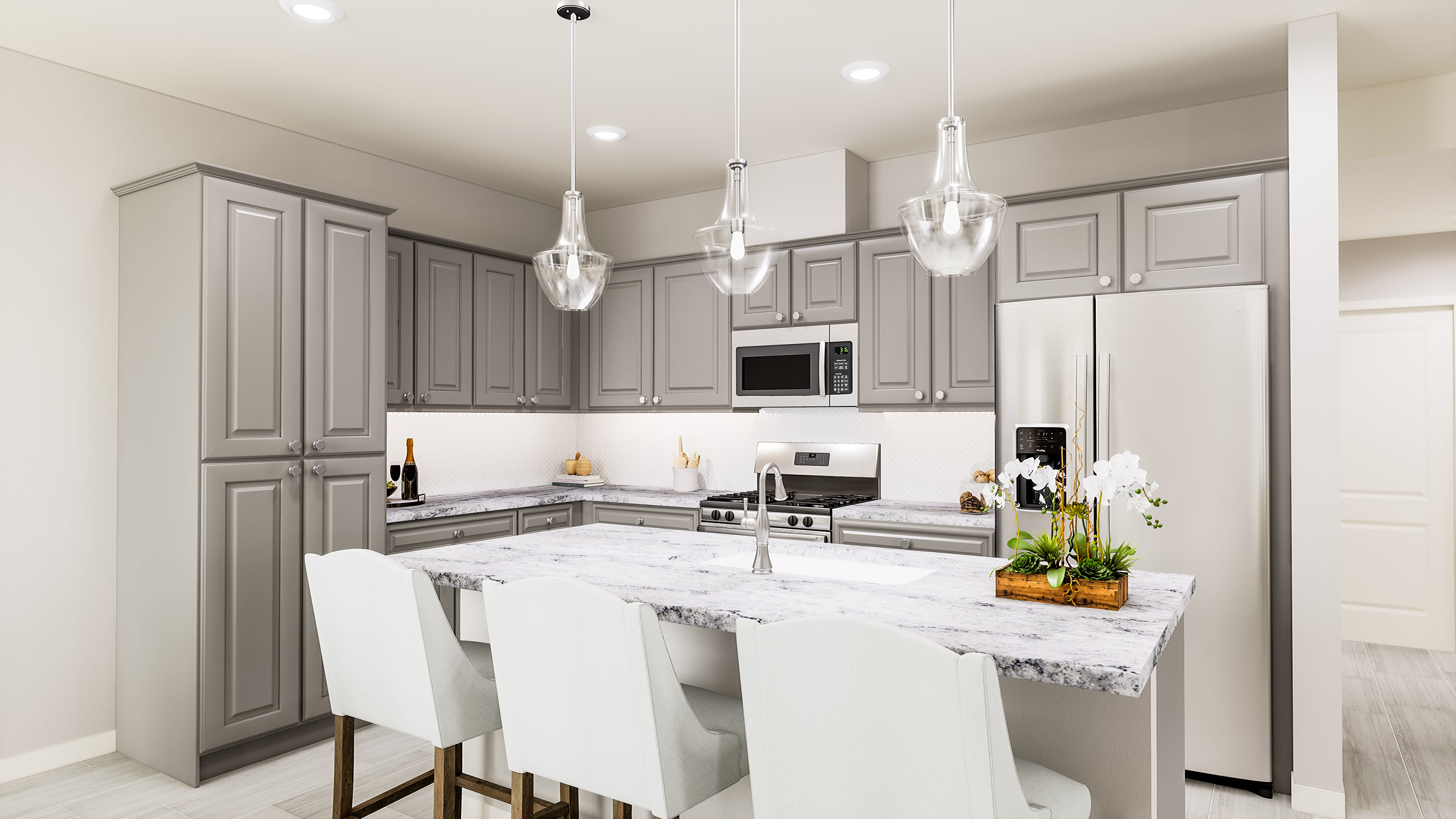 A modern, well-lit kitchen with gray cabinets, white countertops, and pendant lighting fixtures, featuring a kitchen island with stools.