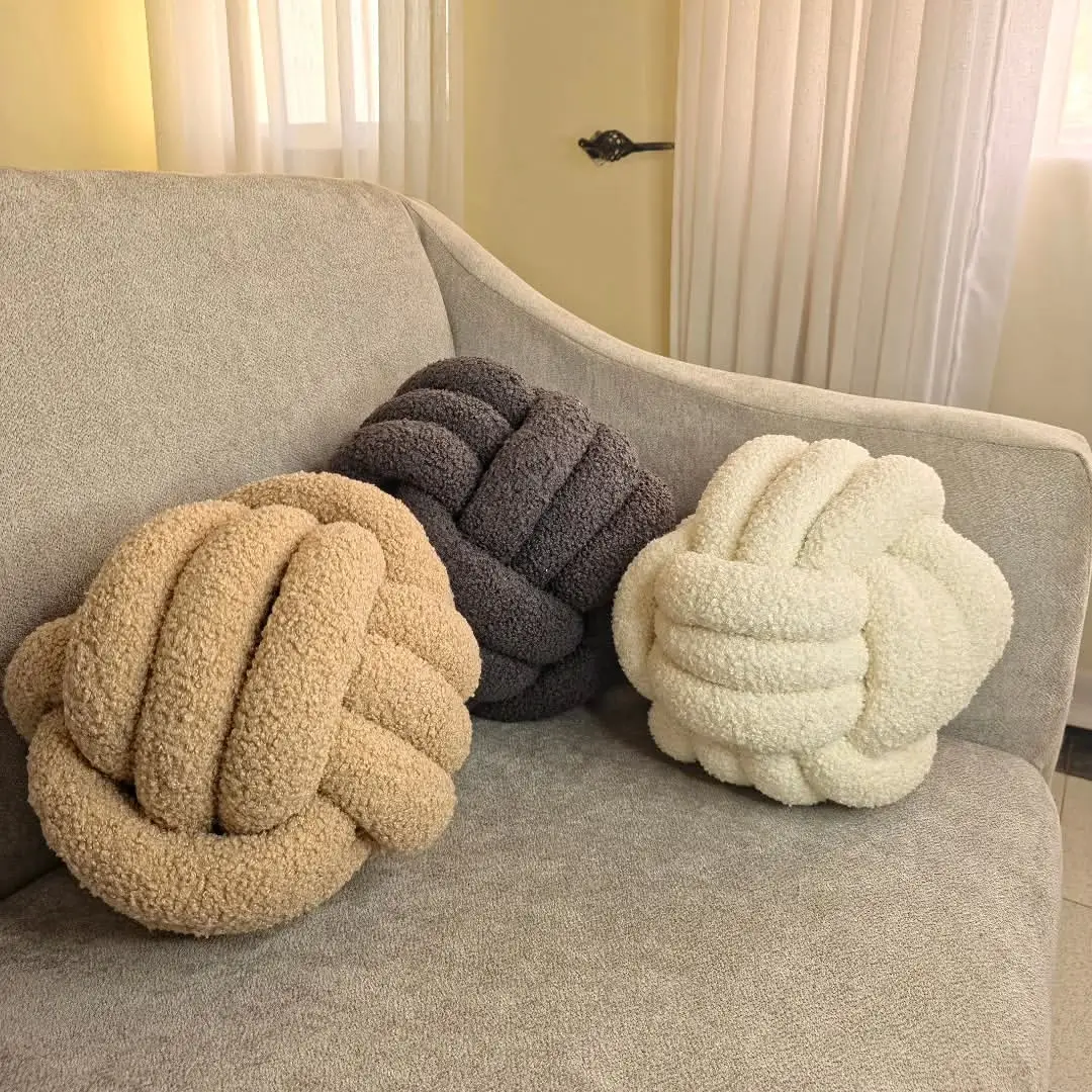 Textured knot cushion adding shape and depth to a grey sofa in Kenya