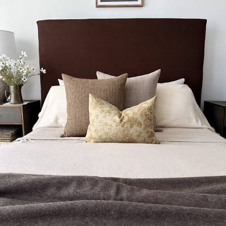 Fresh white bed pillows aired and layered in a bright Kenyan bedroom