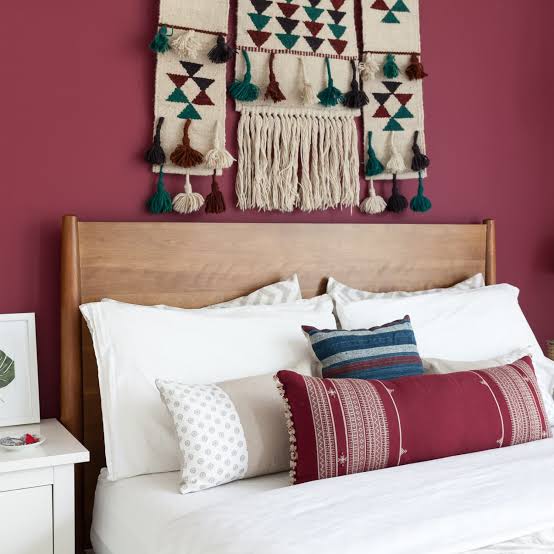 Decorative bedroom pillows and shams layered on a neatly made Kenyan bed