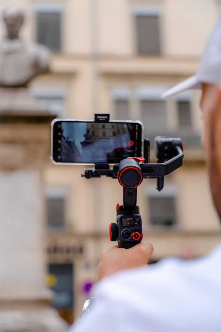 Smartphone mounted on a mobile gimbal filming a business product on location