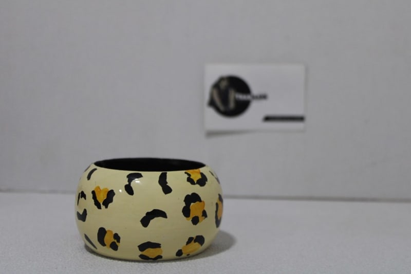 Cream Colored Bangle In Black Painted Design — Wood
