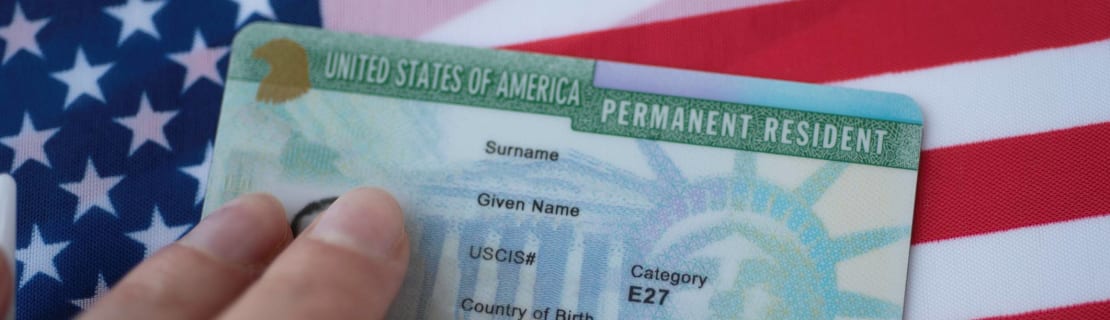 Permanent Resident Green Card Of United States Of America On Flag Of Usa
