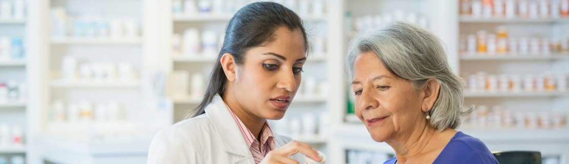Pharmacist Talking To Customer