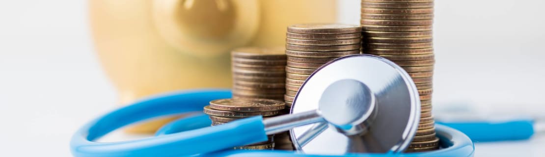 Piggybank With Coins And Stethoscope