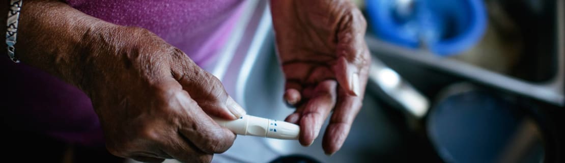 Senior Woman Checking Blood Sugar Levels