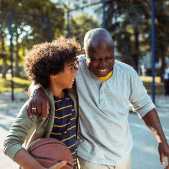 Man playing basketball with grandson