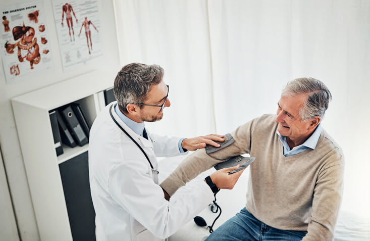 Doctor gives his patient a physical exam