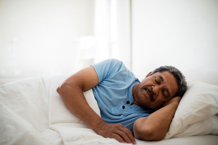 Man asleep in his bed