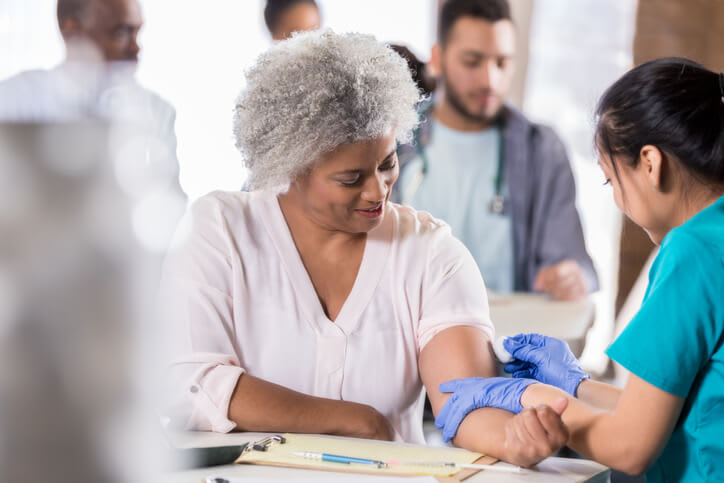 Woman gets a vaccination from her nurse