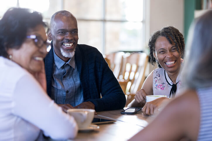 Happy Couple Visiting With Friends
