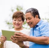 Two people looking at a tablet