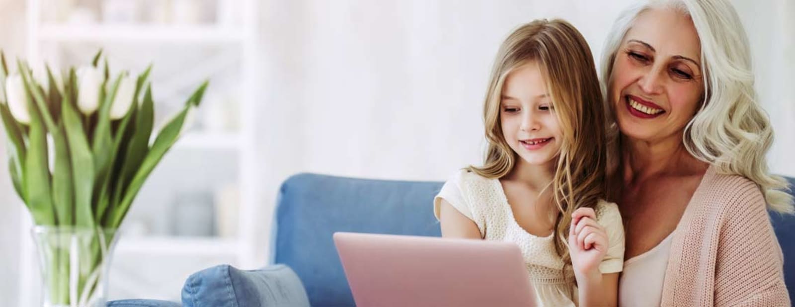 Grandma and granddaughter looking at a tablet