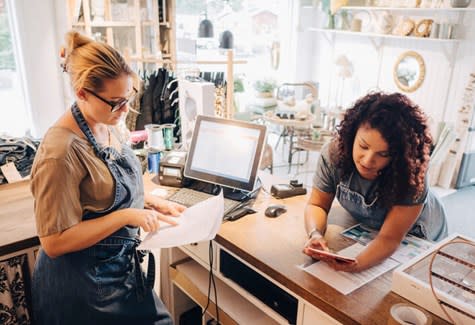 Two small business owners reviewing finances