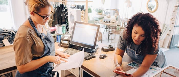 Two small business owners reviewing finances