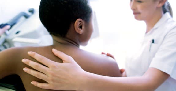 Back view of woman getting a mammogram
