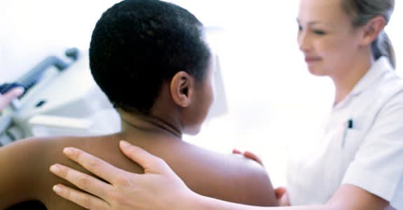 Back view of woman getting a mammogram