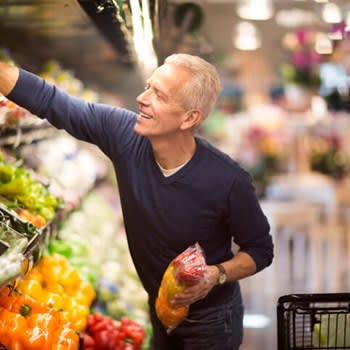 Man buying produce at grocery store