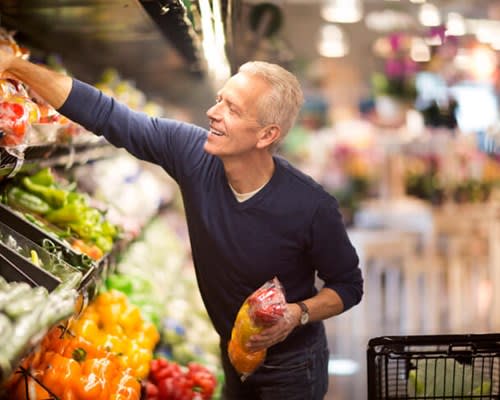 Man buying produce at grocery store