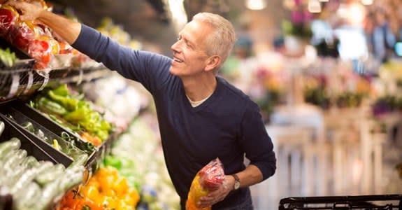 Man buying produce at grocery store