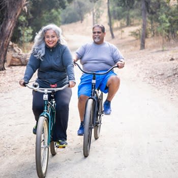 Happy couple riding bicycles outdoors