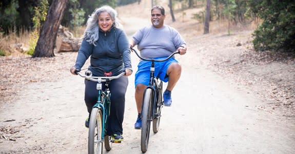 Happy couple riding bicycles outdoors