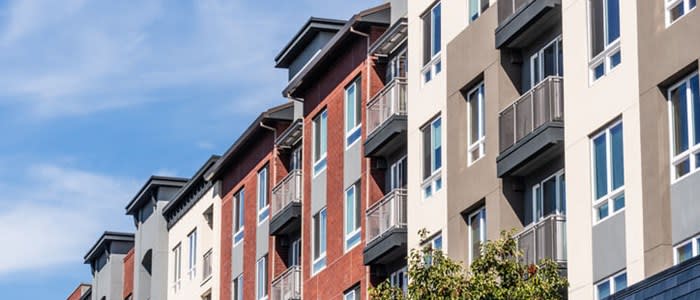 Image of a row of apartment buildings of different colors