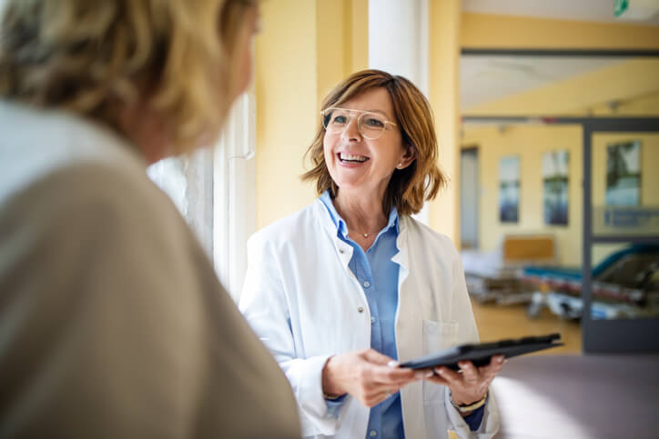 Doctor smiles while reviewing information with her patient