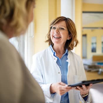 Doctor smiles while reviewing information with her patient