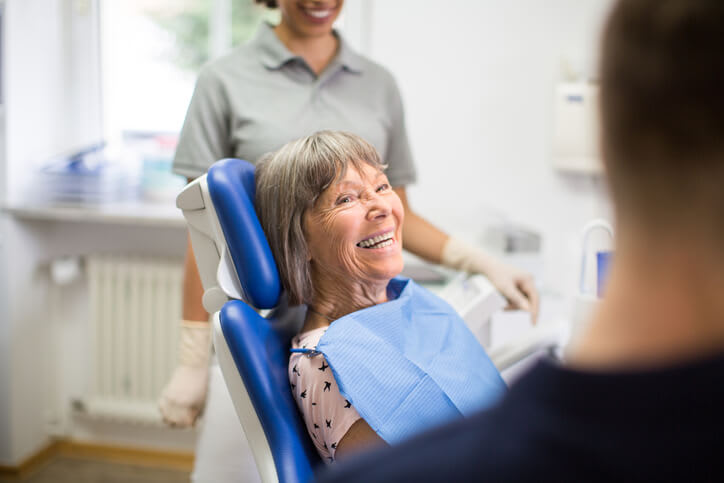 Happy smiling woman in dentist's chair