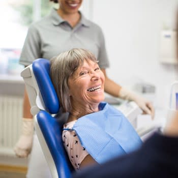 Happy smiling woman in dentist's chair