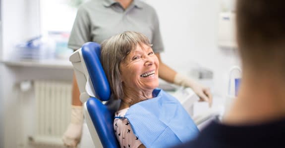 Happy smiling woman in dentist's chair