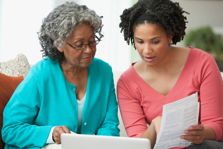 Woman helps her mother review documents