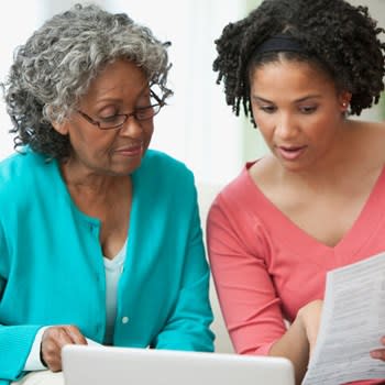 Woman helps her mother review documents