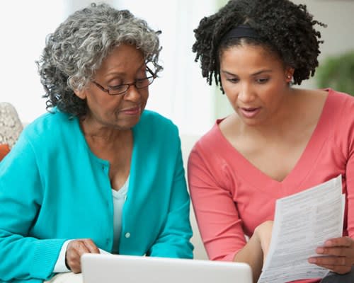 Woman helps her mother review documents