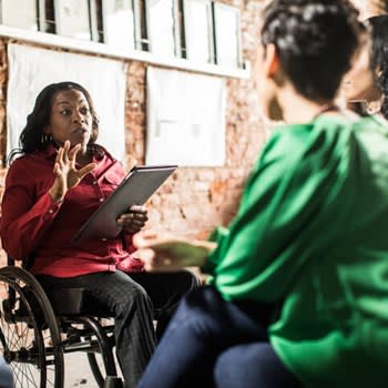 Woman in wheelchair leading group discussion