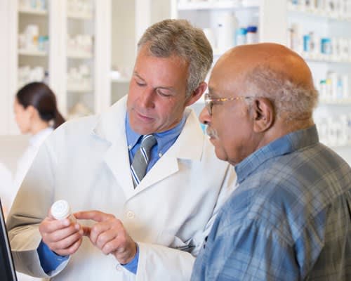 Pharmacist assists patient in pharmacy