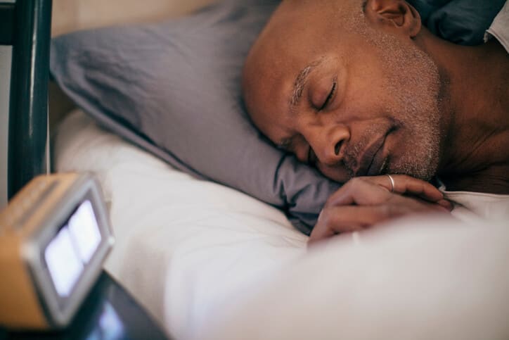 Man sleeps soundly in bed