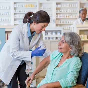 Pharmacist gives flu shot in the pharmacy