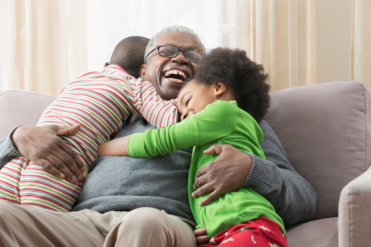 Smiling grandfather with young grandchildren