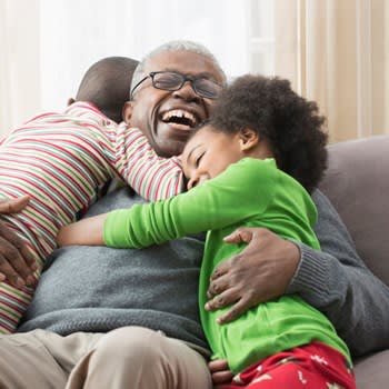 Smiling grandfather with young grandchildren