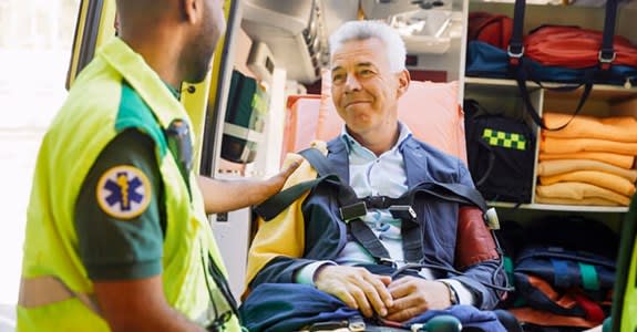 EMT comforts man about to be transported by ambulance