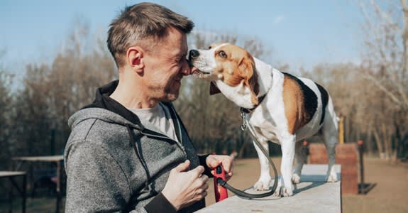 Dog licks owner on the face